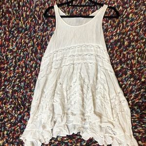 Swimsuit coverup with lace inserts and uneven hem.